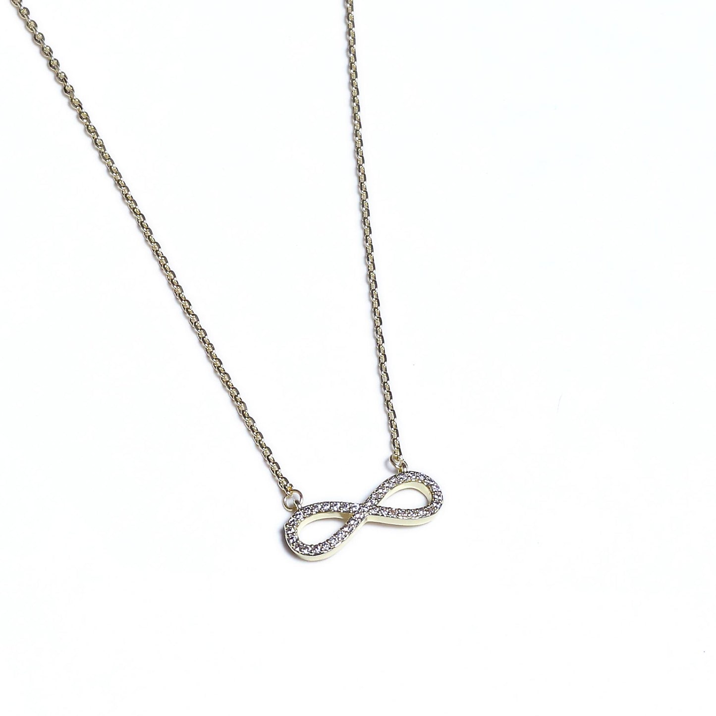 Glimii dainty infinity pendant necklace with silver chain and crystal accents on white background