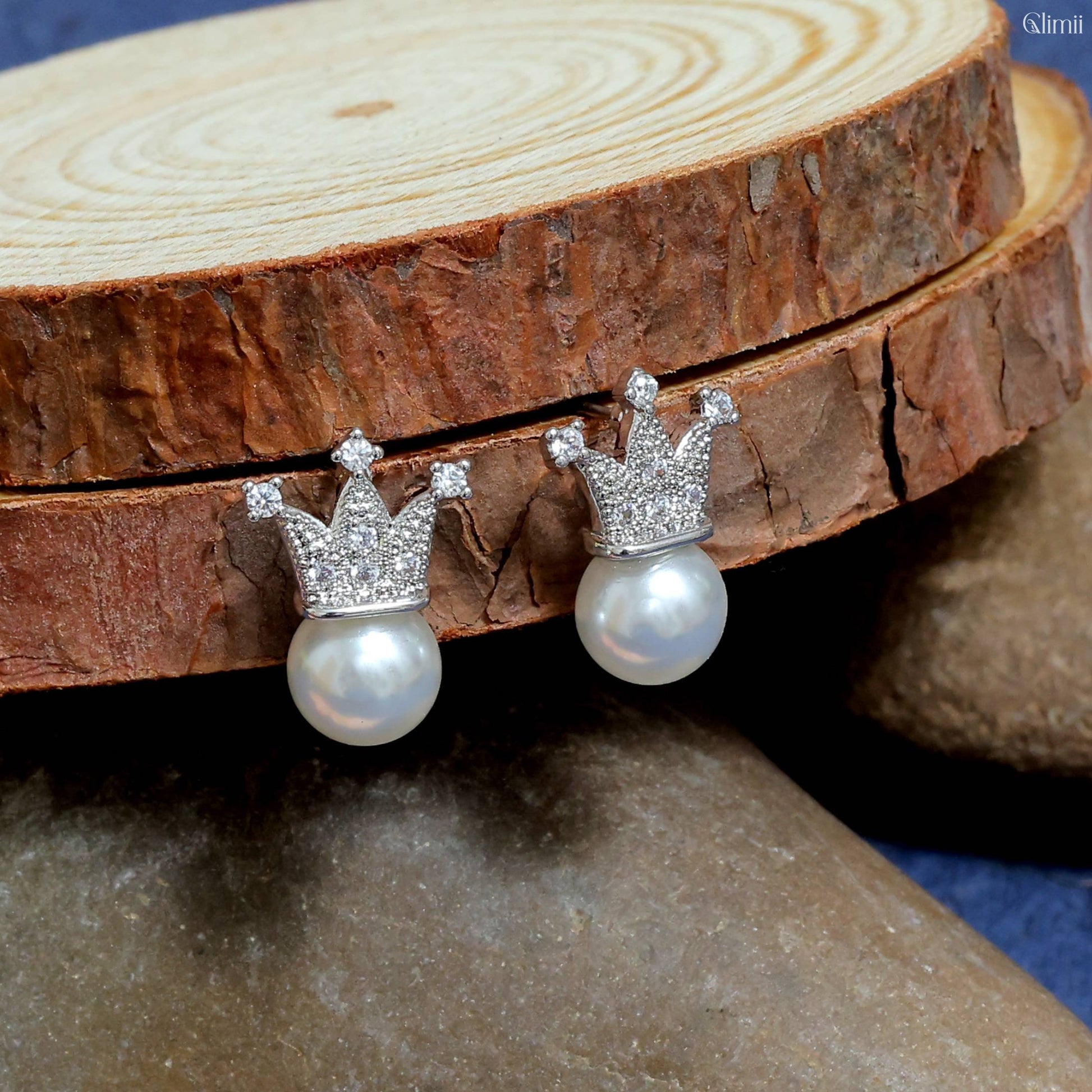 Glimii elegant pearl crown earrings with sparkling crown design and round white pearls on wooden display