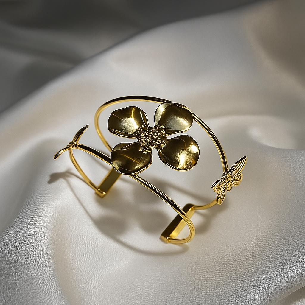 Glimii gold flower bracelet with a large flower centerpiece and delicate butterfly detail