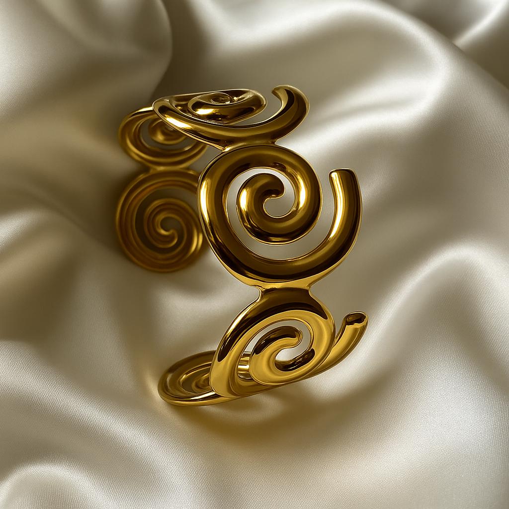 Glimii gold plated statement bracelet with intricate spiral design on satin fabric