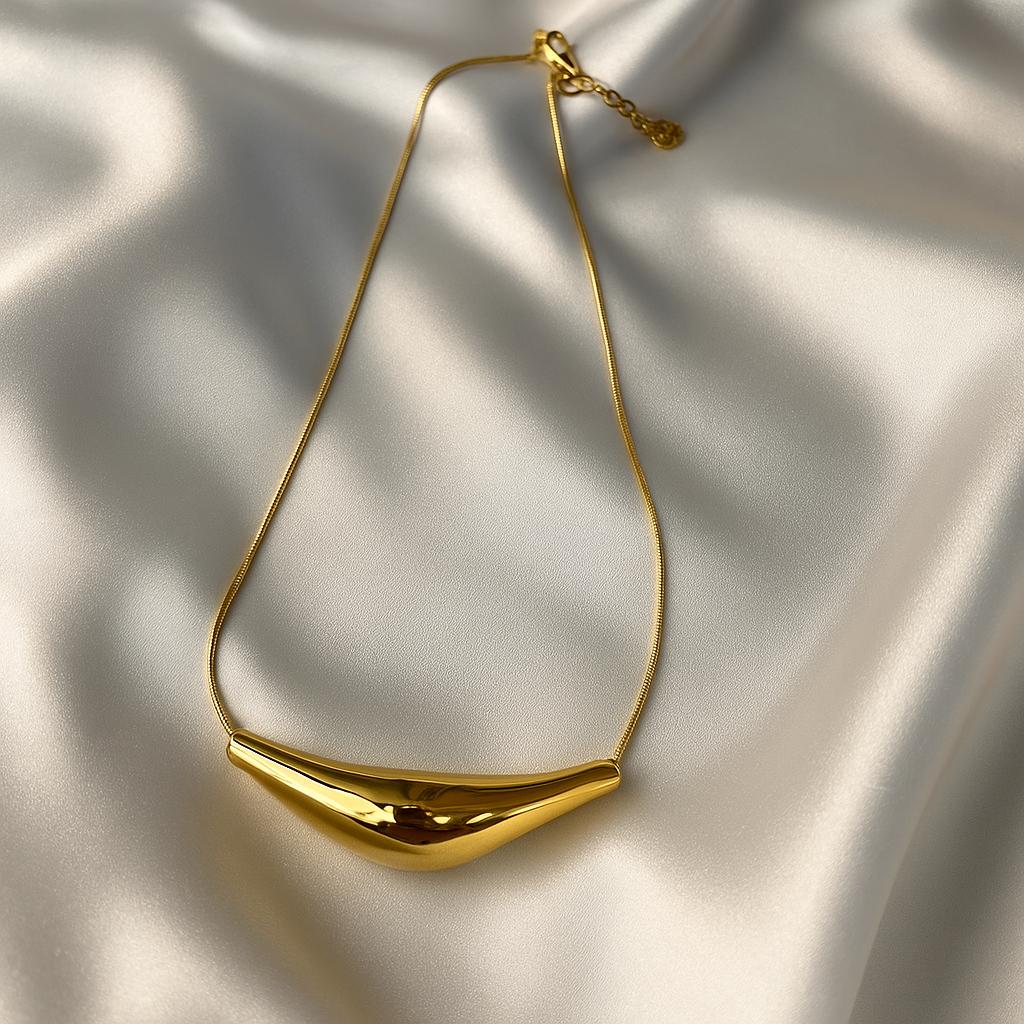 Glimii gold plated statement necklace with smooth curved pendant on a delicate chain