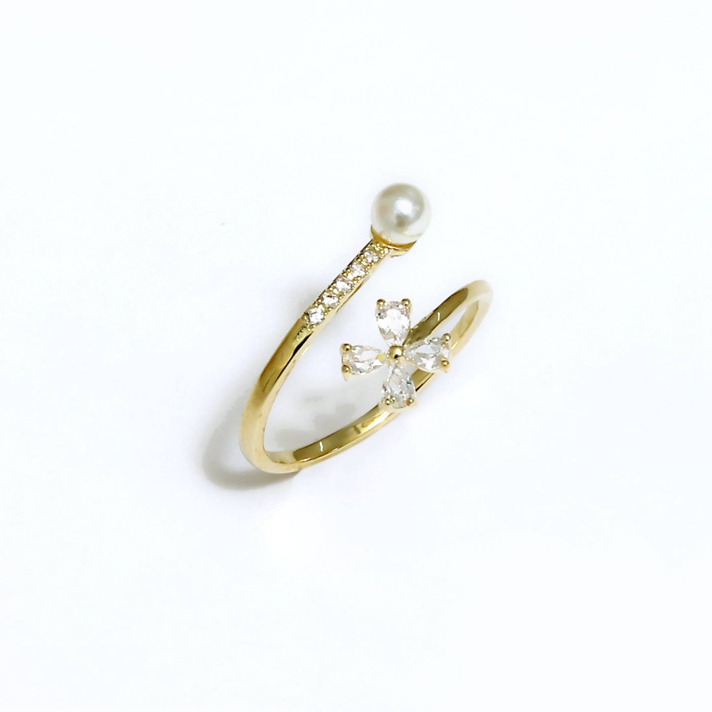Glimii gold ring featuring delicate pearl flower jewelry design with small crystals on white background