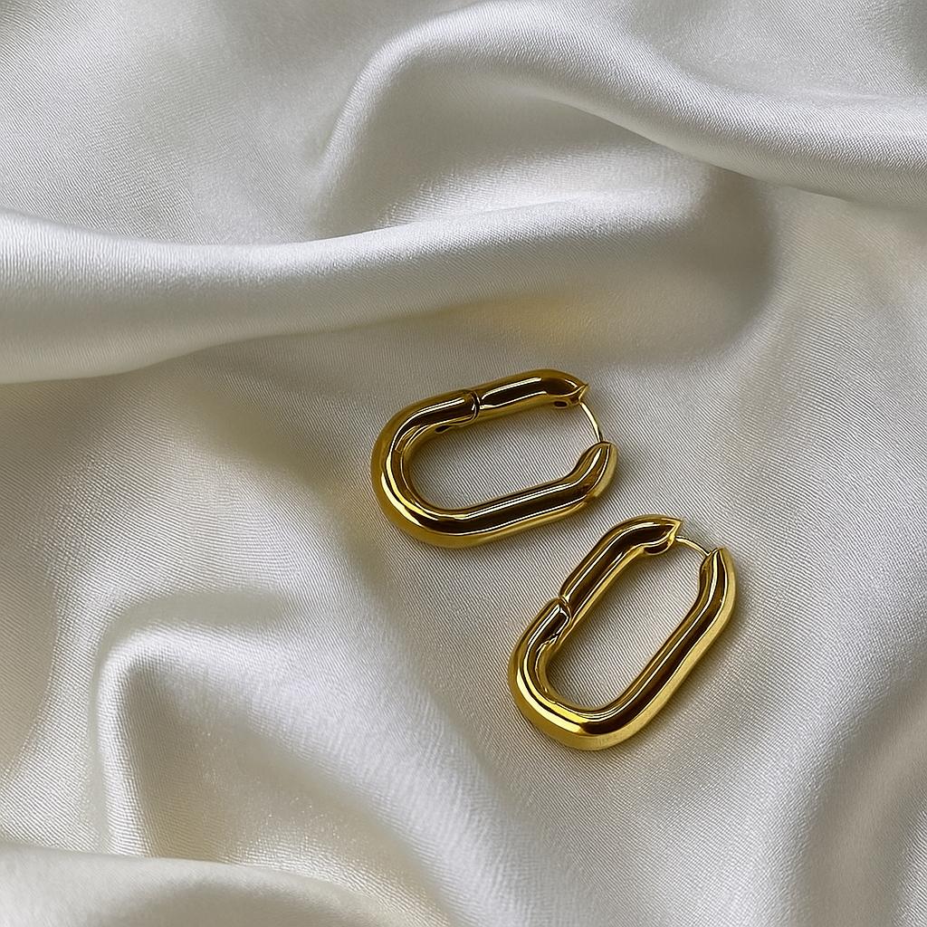 Glimii gold stainless steel hoop earrings with rectangular shape on white satin fabric