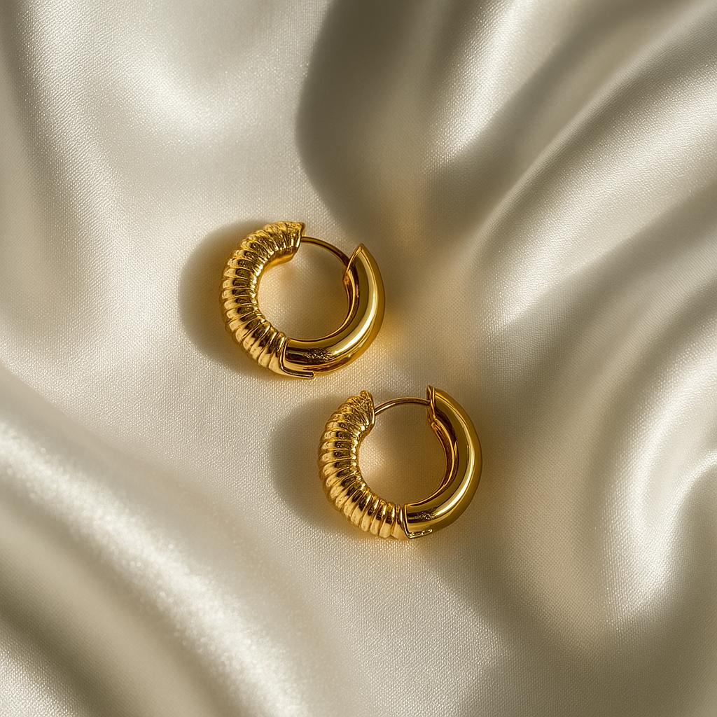 Glimii Korean style gold hoops with textured and smooth design on silky fabric background