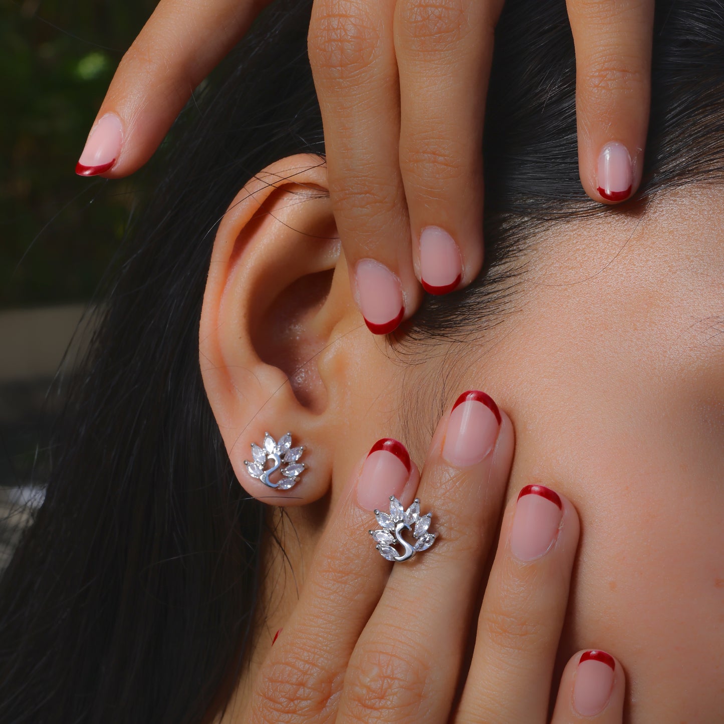 Glimii Korean style stud earrings shaped like elegant silver floral designs worn on ear