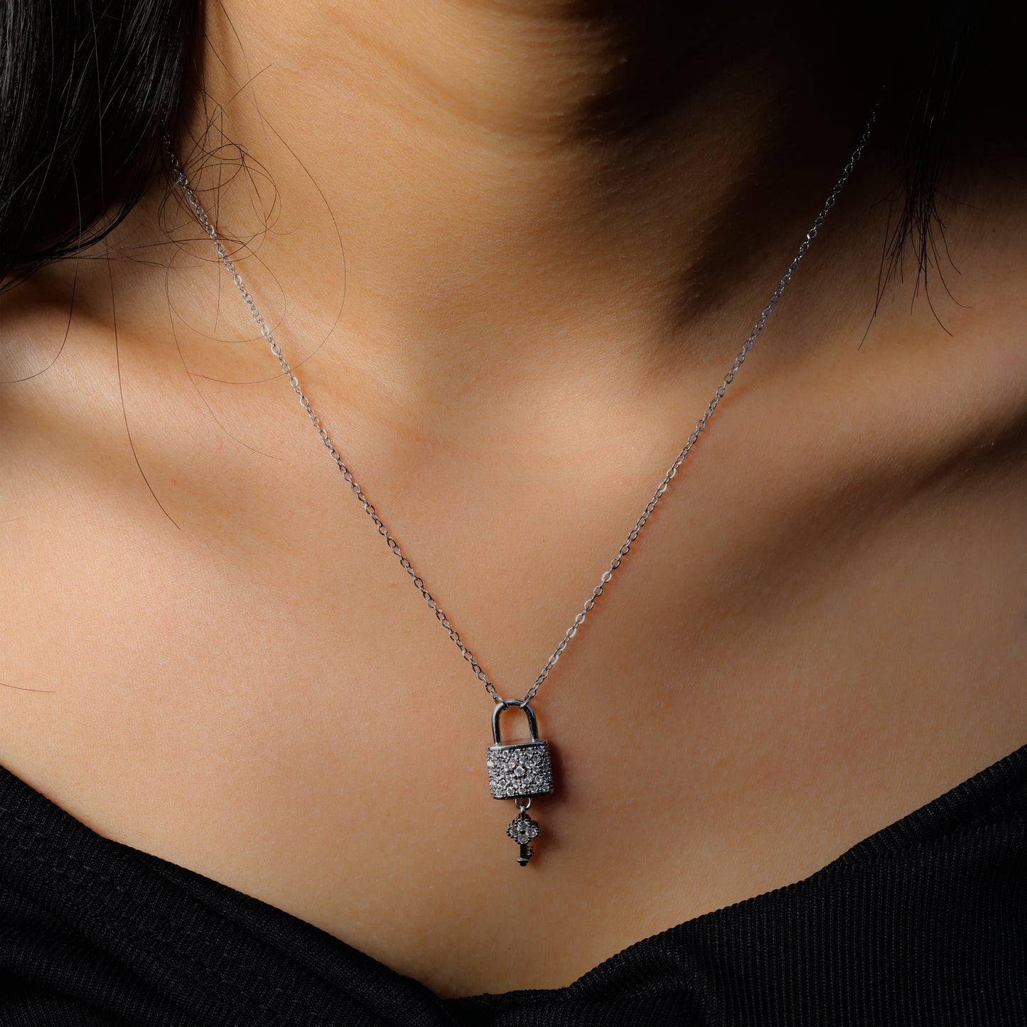 Glimii lock and key necklace with silver chain and sparkling pendant worn on neck