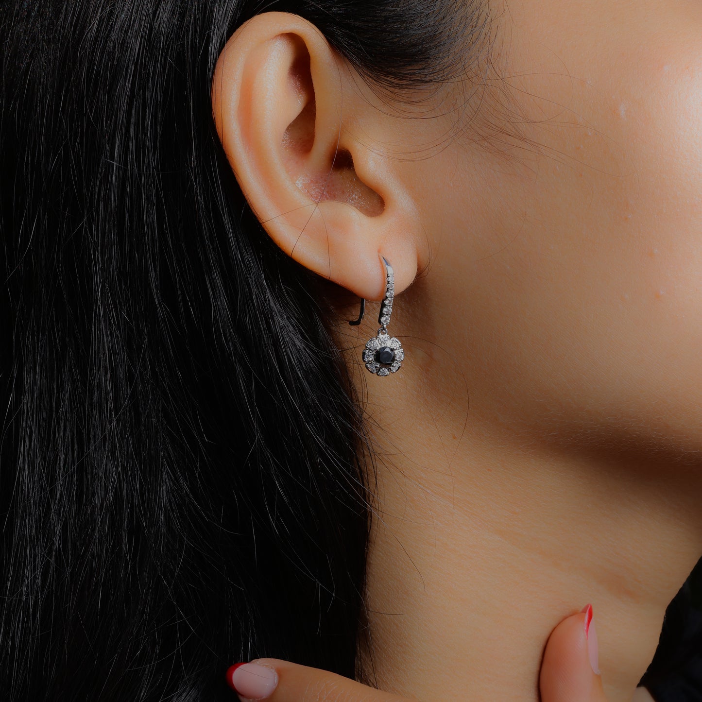 Glimii minimalist black drop earrings with silver accents worn on ear showcasing elegant design