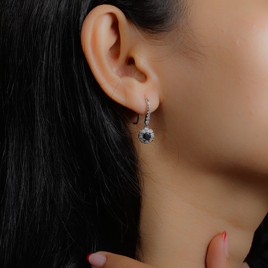 Glimii minimalist black drop earrings with silver accents worn on ear showcasing elegant design
