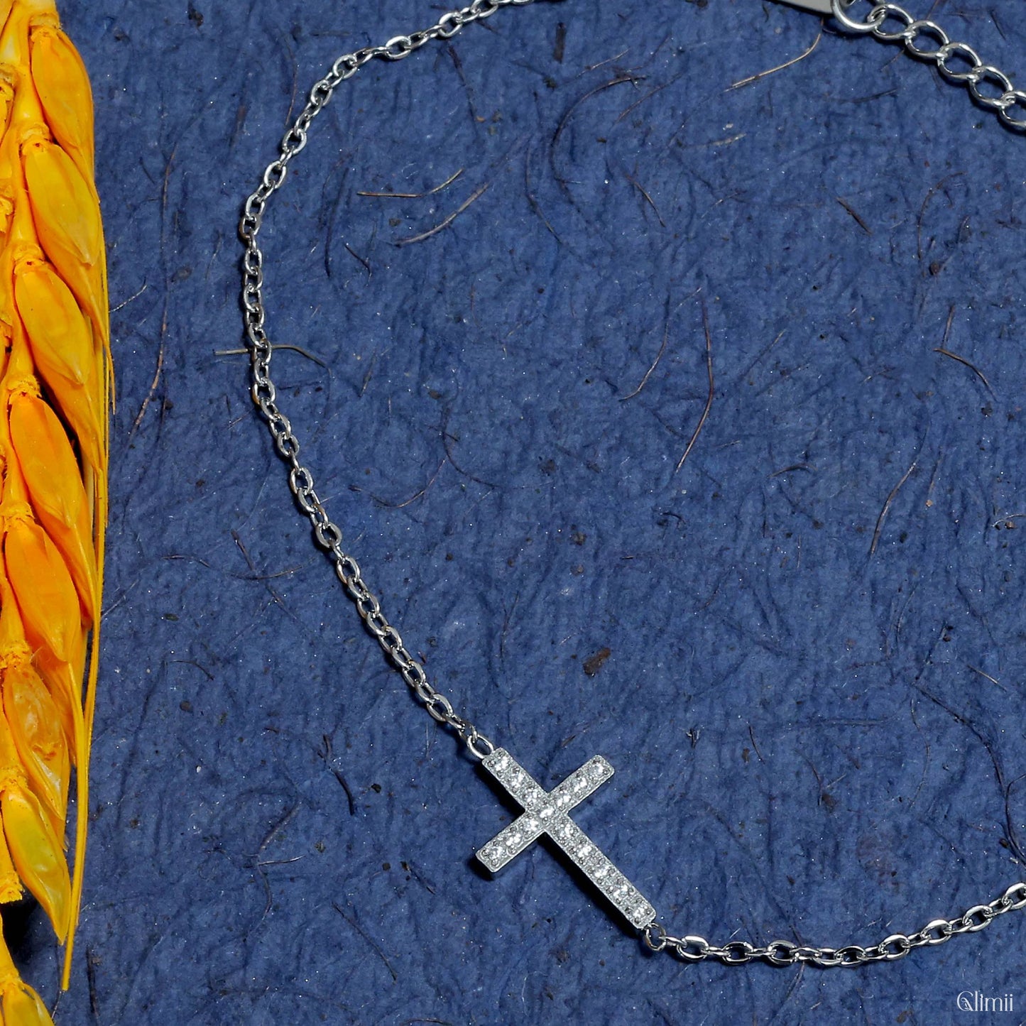 Glimii minimalist cross bracelet with a delicate silver chain and small sparkling cross pendant