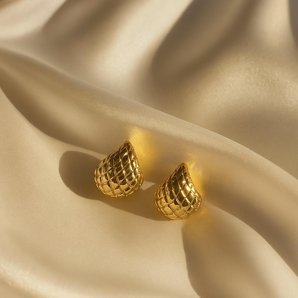 Glimii minimalist gold cuff earring with textured design on soft beige fabric background