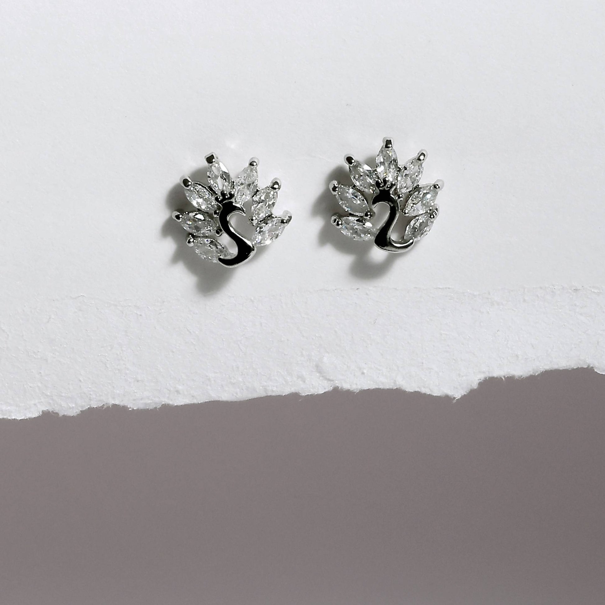 Glimii Korean style stud earrings with silver peacock design and clear crystal accents