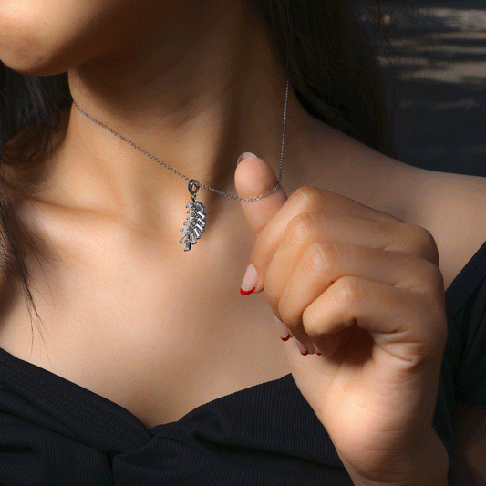 Glimii stainless steel dainty necklace with leaf pendant worn on neck with black top