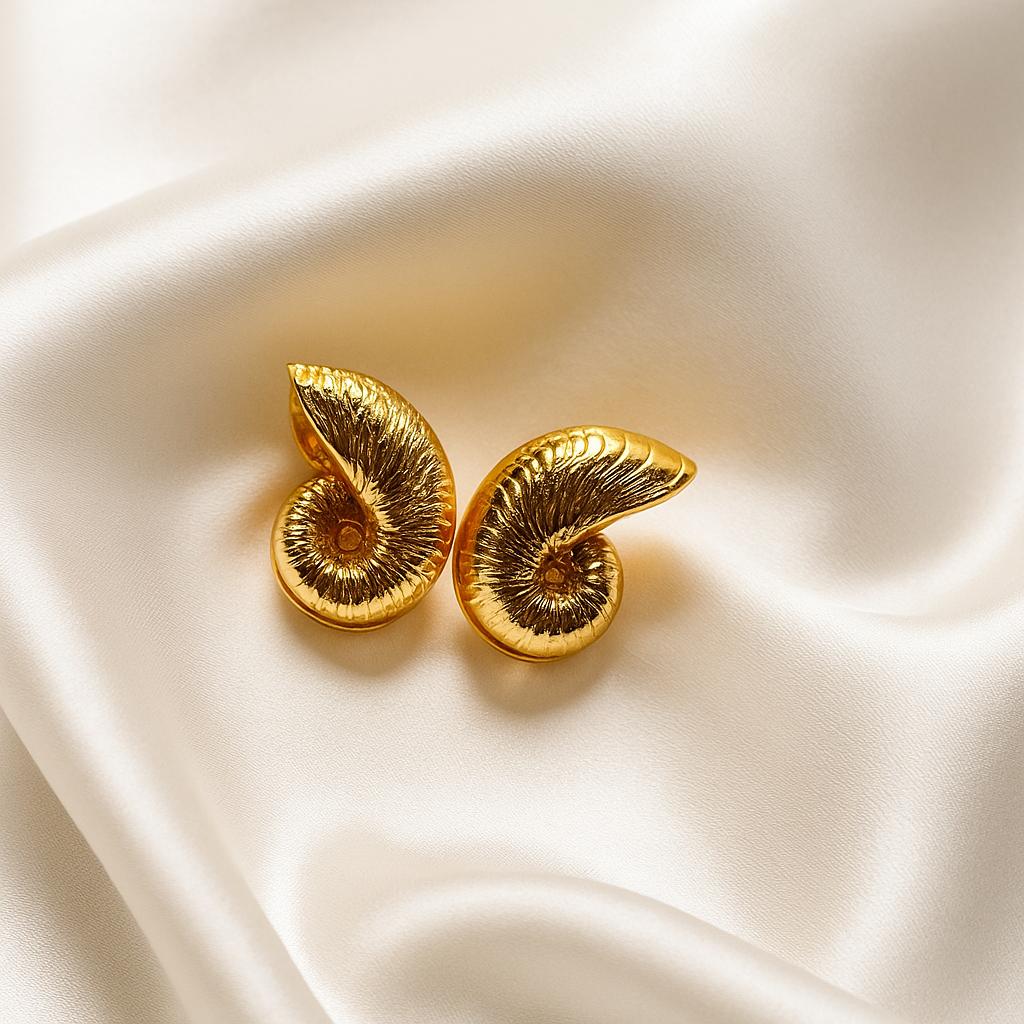 Glimii gold-tone stainless steel shell jewelry earrings with a spiral shell design on satin background