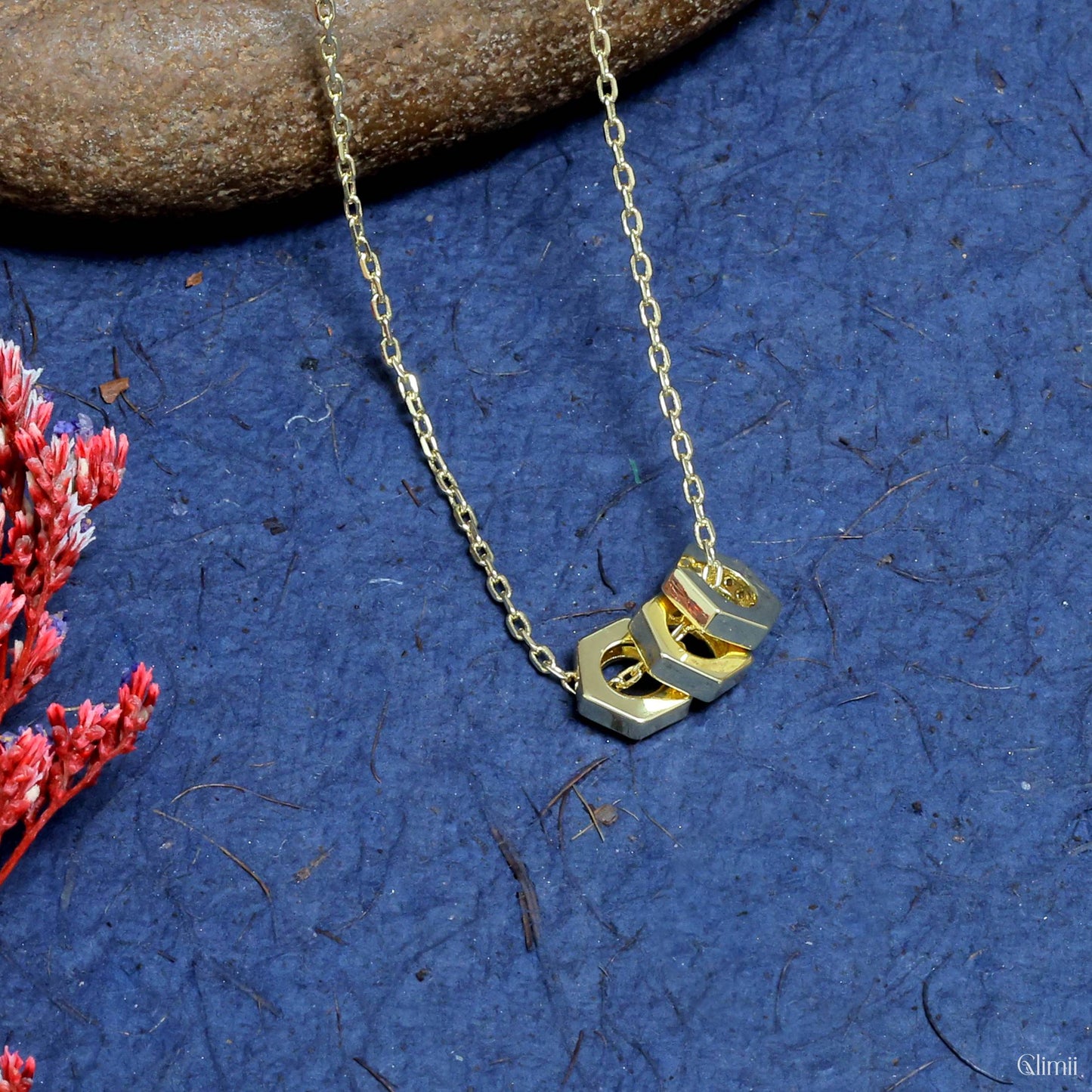 Glimii gold chain everyday aesthetic necklace with geometric hexagon pendant on blue background