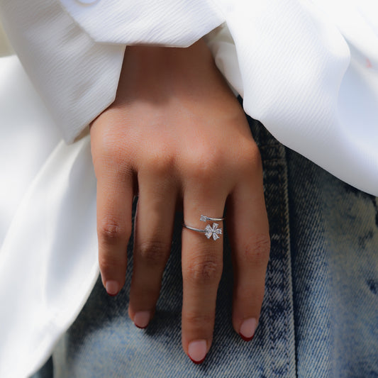 Glimii delicate flower jewelry for women featuring a silver floral ring on hand with white sleeve and denim