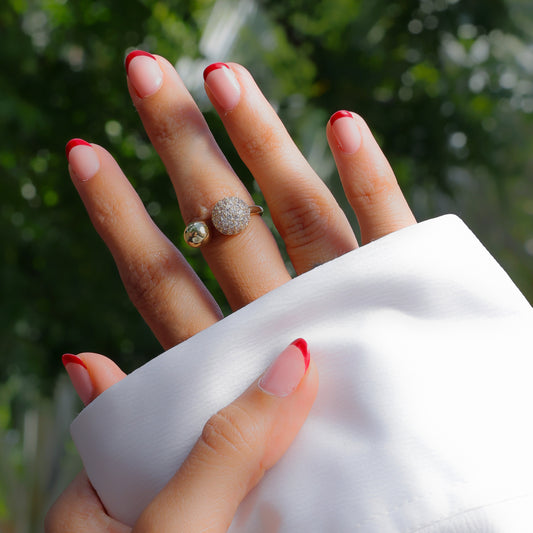 Glimii dainty everyday stacking ring with sparkling stones on hand with red French manicure