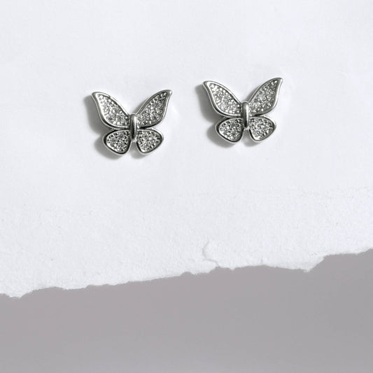 Glimii silver butterfly stud earrings with sparkling crystal details on white background