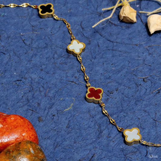 Glimii clover charm bracelet with black white and red four-leaf clover charms on gold chain