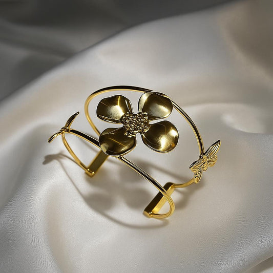 Glimii gold flower bracelet with a large flower centerpiece and delicate butterfly detail