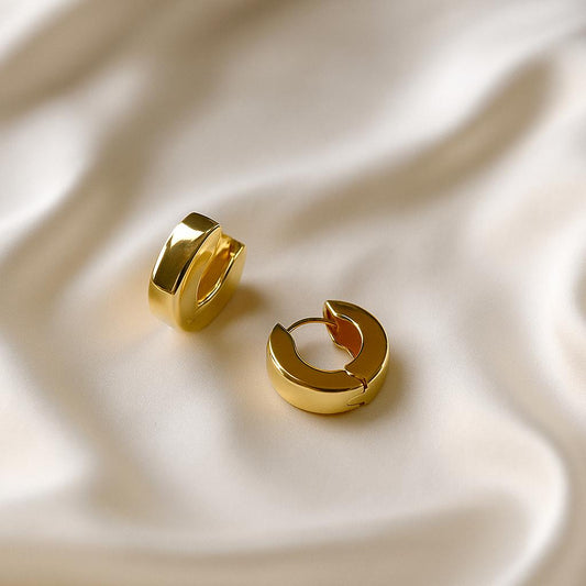 Glimii minimalist round hoops for women in shiny gold on soft white fabric background