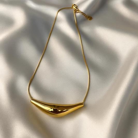 Glimii gold plated statement necklace with smooth curved pendant on a delicate chain