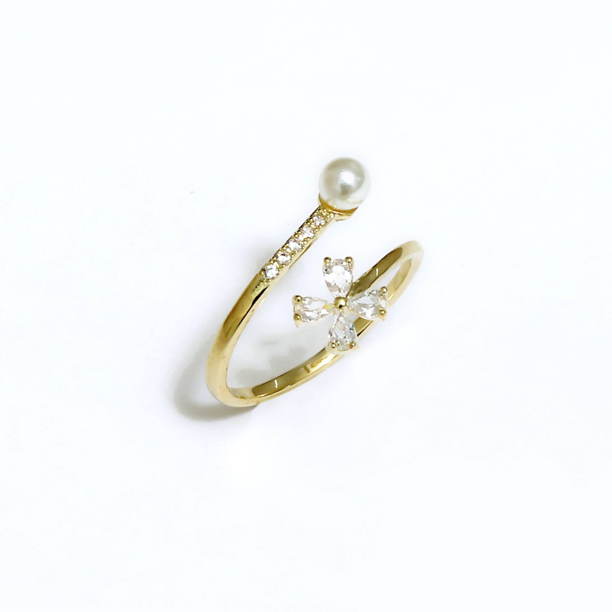 Glimii gold ring featuring delicate pearl flower jewelry design with small crystals on white background