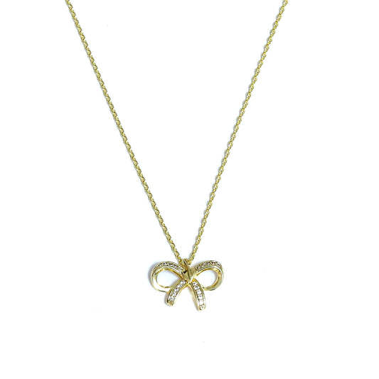 Gold Korean style bow necklace with delicate chain and small crystal accents on a white background