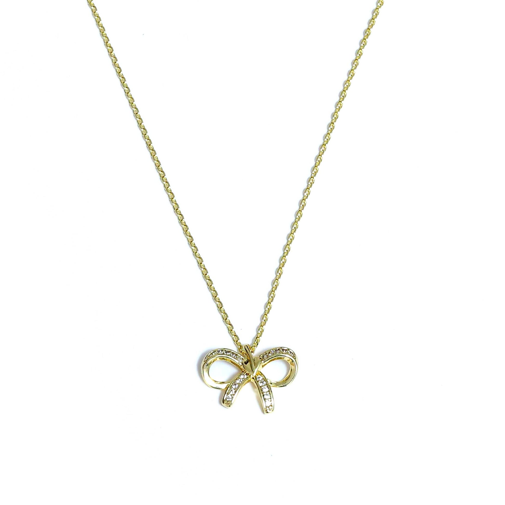 Gold Korean style bow necklace with delicate chain and small crystal accents on a white background