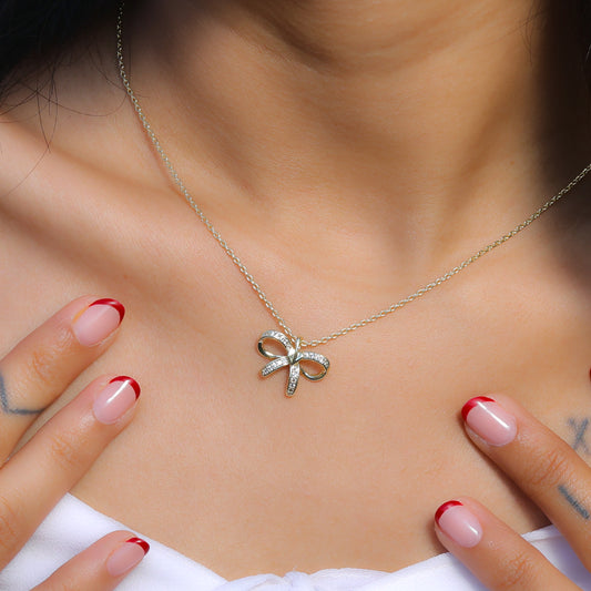 Glimii Korean style bow necklace with delicate silver chain worn on model neck