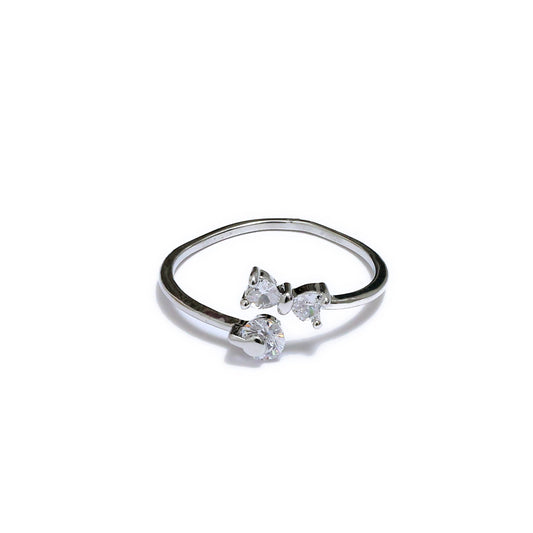 Glimii minimalist bow ring for women in silver with three clear crystal accents on white background