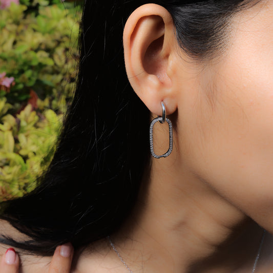 Glimii minimalist statement earrings worn on ear featuring silver rectangular hoop design with small rhinestones