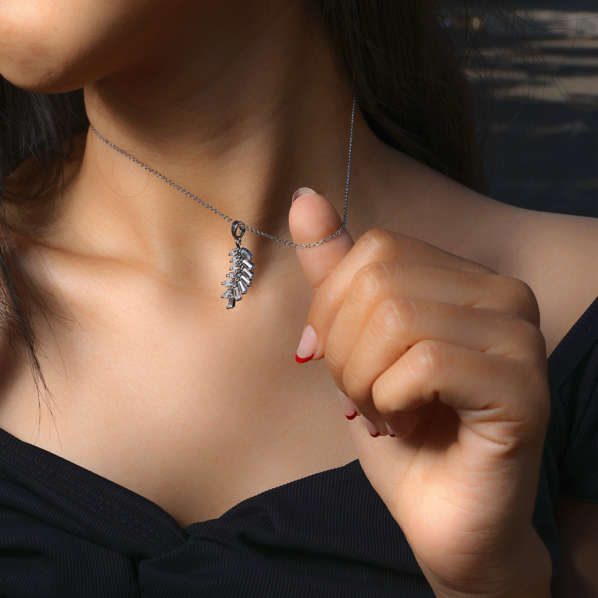Glimii stainless steel dainty necklace with leaf pendant worn on neck with black top