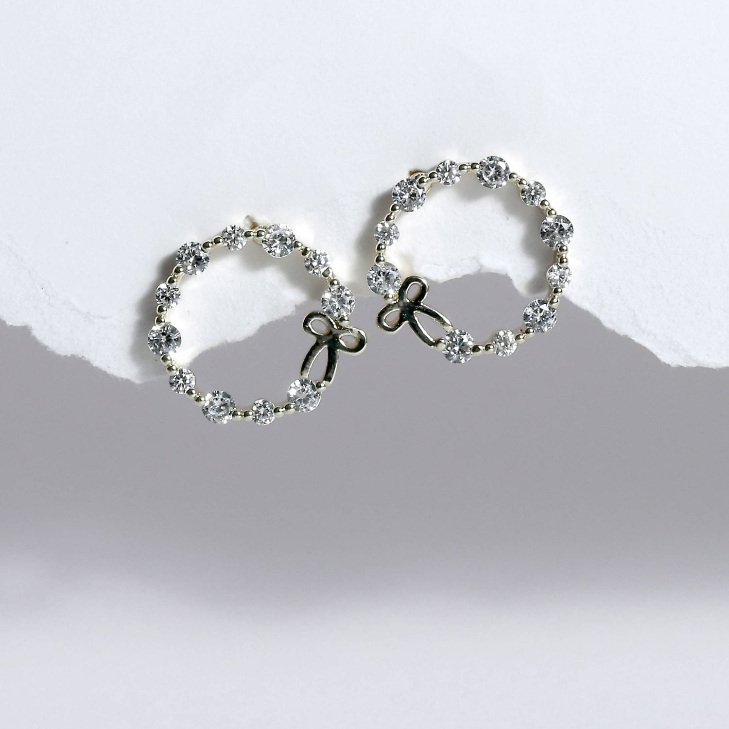 Glimii stainless steel hoop earrings with sparkling crystals and delicate bow design