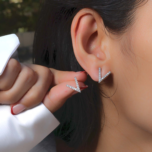 Glimii stainless steel stud earrings in V shape with sparkling stones worn on ear